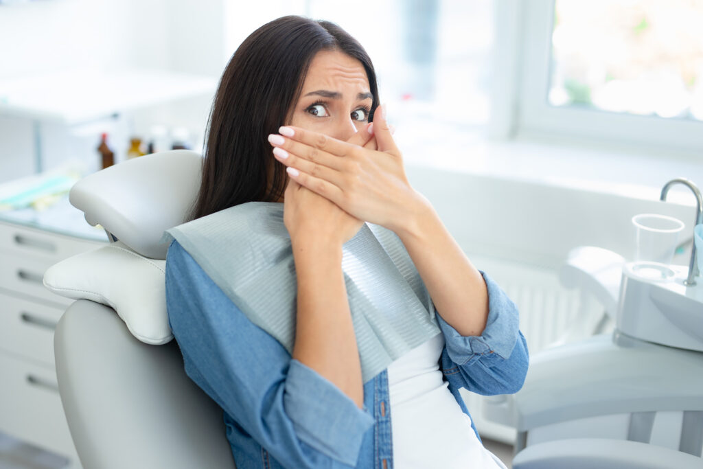 Portrait Woman Covering Mouth With Hands Sirring Dental Chair Portrait Woman Covering Mouth With Hands Sirring Dental Chair