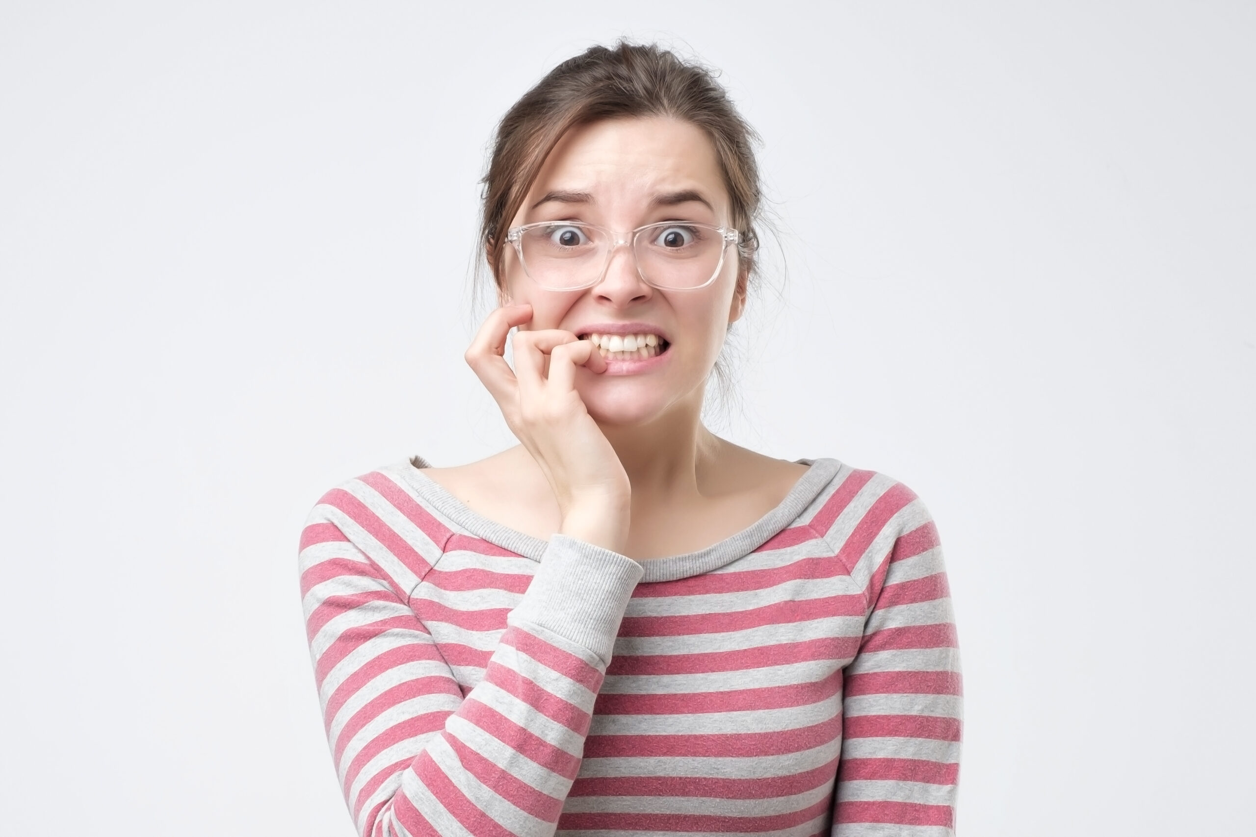 Worried Female Looks Nervously Bites Finger Nails Watches Moving Horror Film Scaled Worried Female Looks Nervously Bites Finger Nails Watches Moving Horror Film Scaled