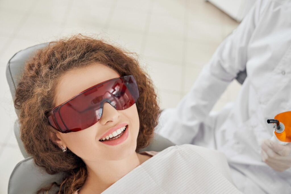 Beautiful Woman Lying Dental Chair Protective Glasses 7502 2412 Beautiful Woman Lying Dental Chair Protective Glasses 7502 2412