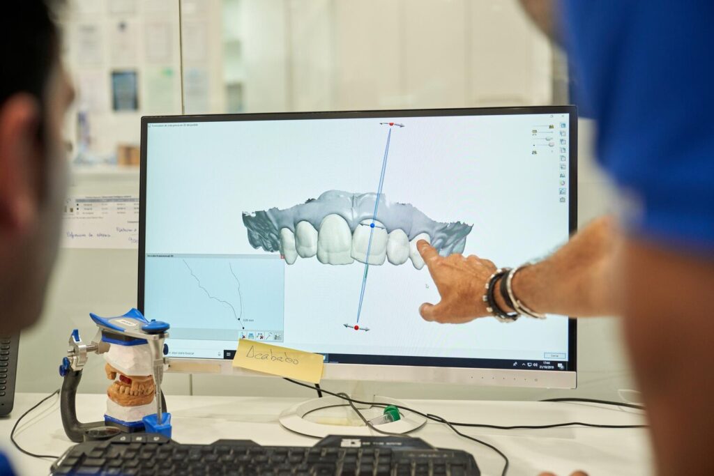 Crop Blurred Anonymous Dentists Pointing Monitor While Modeling Denture Computer While Working Together Modern Light Dental Clinic 935394 3245 Crop Blurred Anonymous Dentists Pointing Monitor While Modeling Denture Computer While Working Together Modern Light Dental Clinic 935394 3245