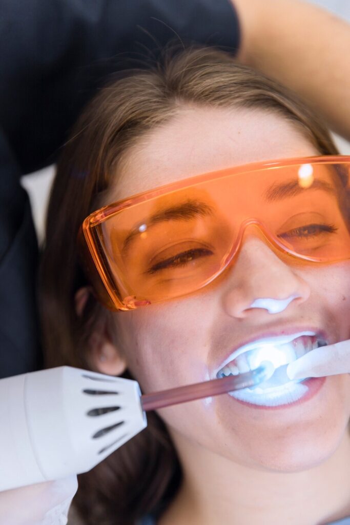 Female Patient S Face Going Through Laser Teeth Whitening Treatment 23 2147879302 Female Patient S Face Going Through Laser Teeth Whitening Treatment 23 2147879302